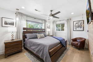 Bedroom featuring light wood-style floors, a ceiling fan, and recessed lighting
