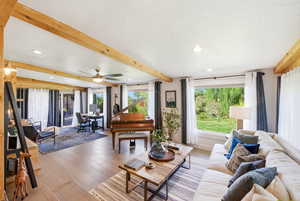 Living room featuring beamed ceiling, recessed lighting, light wood-style floors, and ceiling fan