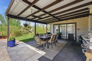 View of patio / terrace featuring outdoor dining space and a grill
