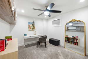 Office space featuring light carpet, ceiling fan, and recessed lighting