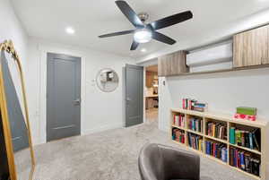 Living area with light carpet, recessed lighting, and a ceiling fan