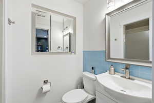 Bathroom featuring vanity and tile walls