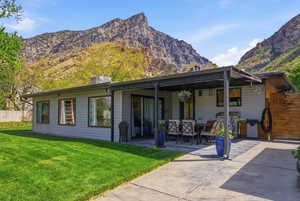 Back of house featuring a patio area and a mountain view