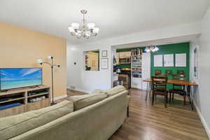 Living area featuring a chandelier and dark wood finished floors