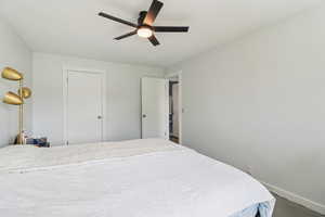 Bedroom with ceiling fan and baseboards
