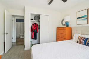 Bedroom featuring carpet floors, a closet, and a ceiling fan