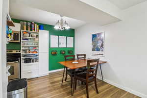Dining space featuring a chandelier and light wood-style flooring