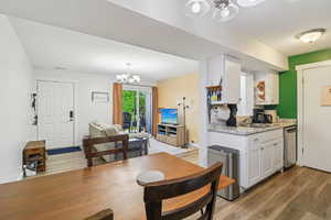 Dining room featuring hanging lights and dark wood finished floors
