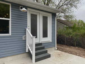 Back property entrance featuring a patio