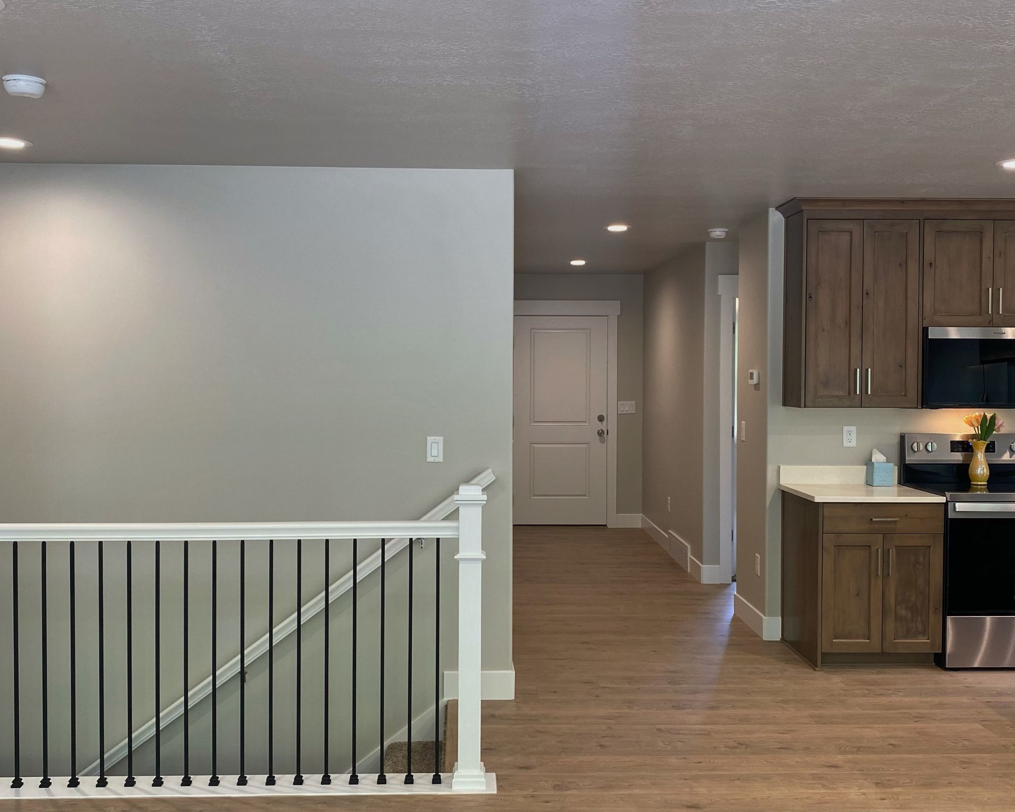 Kitchen featuring stainless steel appliances, light wood finished floors, dark wood finish cabinets, and recessed lighting