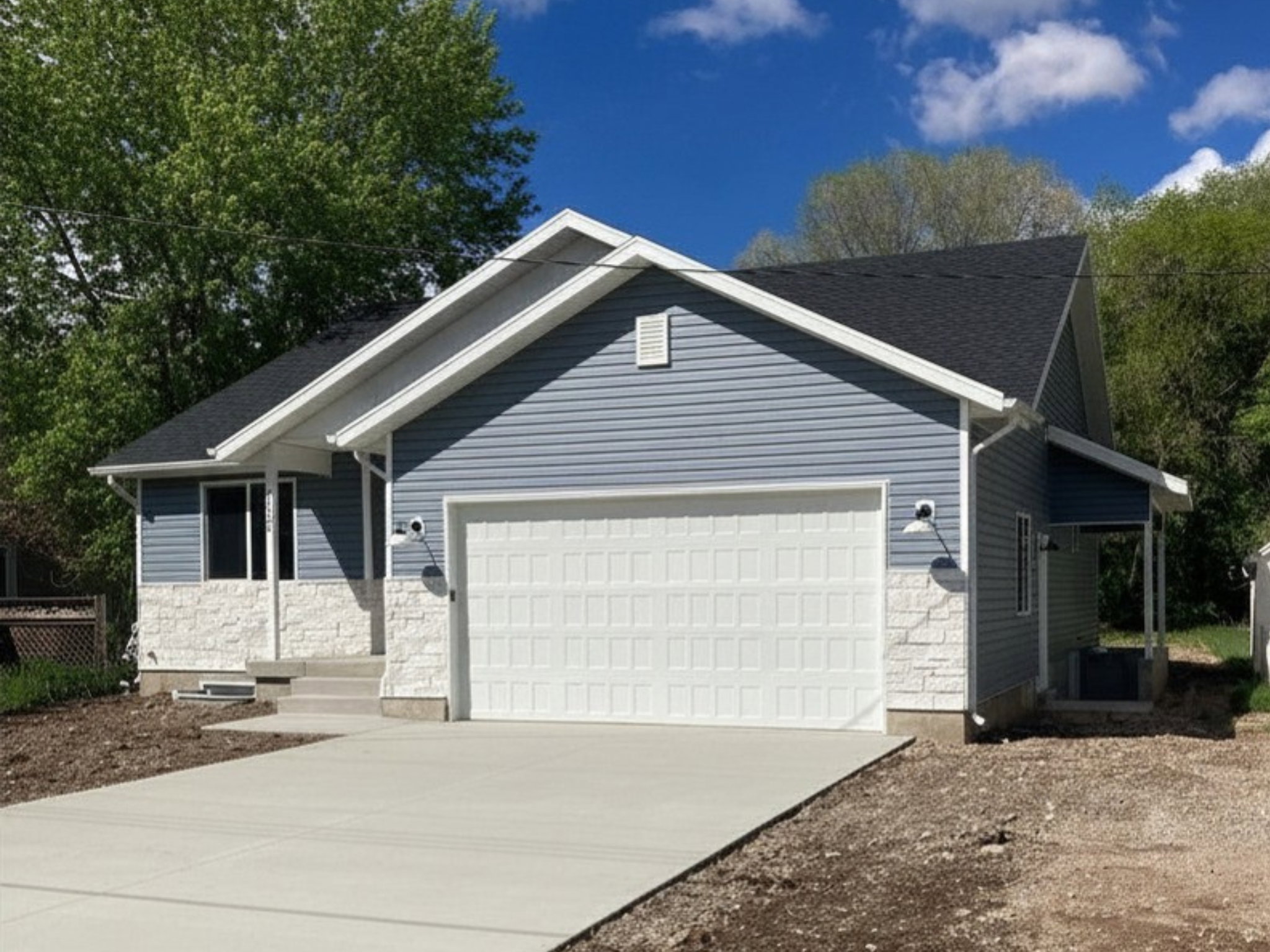 Contemporary exterior with blue horizontal siding and white stone accenting