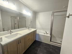 Full bathroom with a shower stall, double vanity, a bath, and a textured ceiling