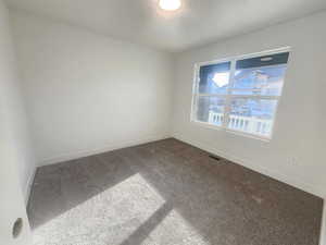 Unfurnished room with carpet flooring and baseboards