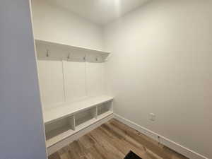 Mudroom featuring light wood-style floors and baseboards