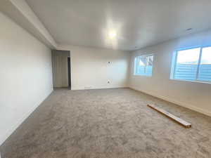 Spare room with carpet and baseboards