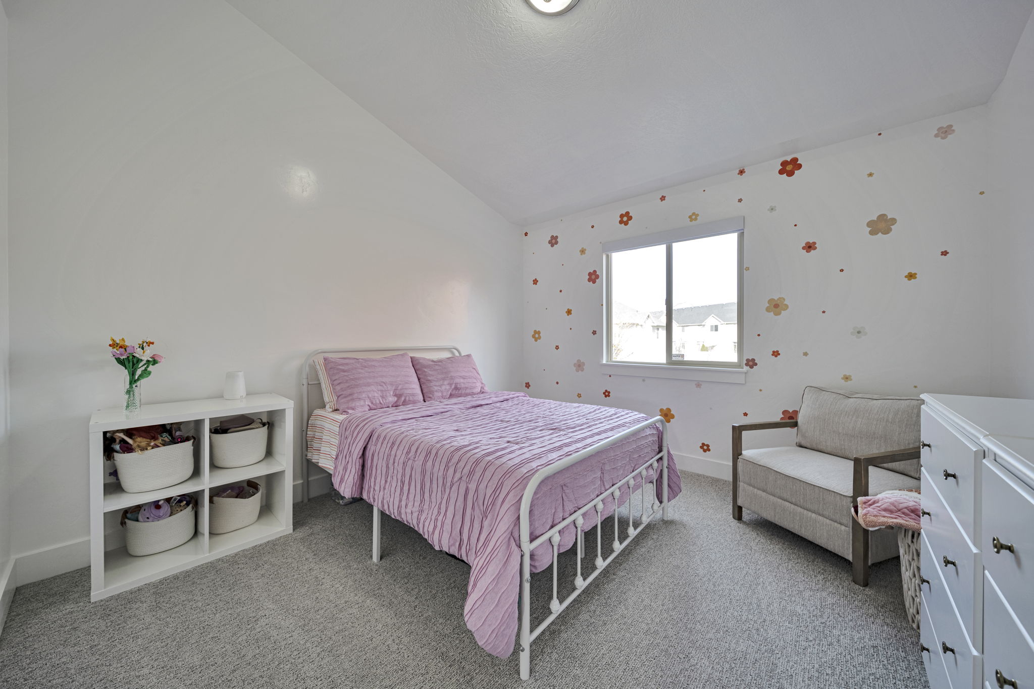 Bedroom featuring lofted ceiling and light colored carpet