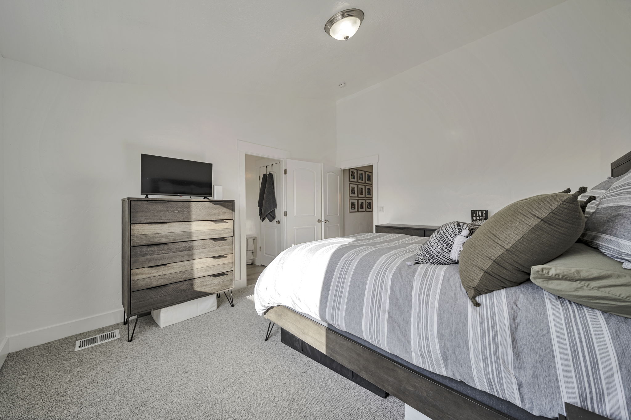 Bedroom with light colored carpet and baseboards