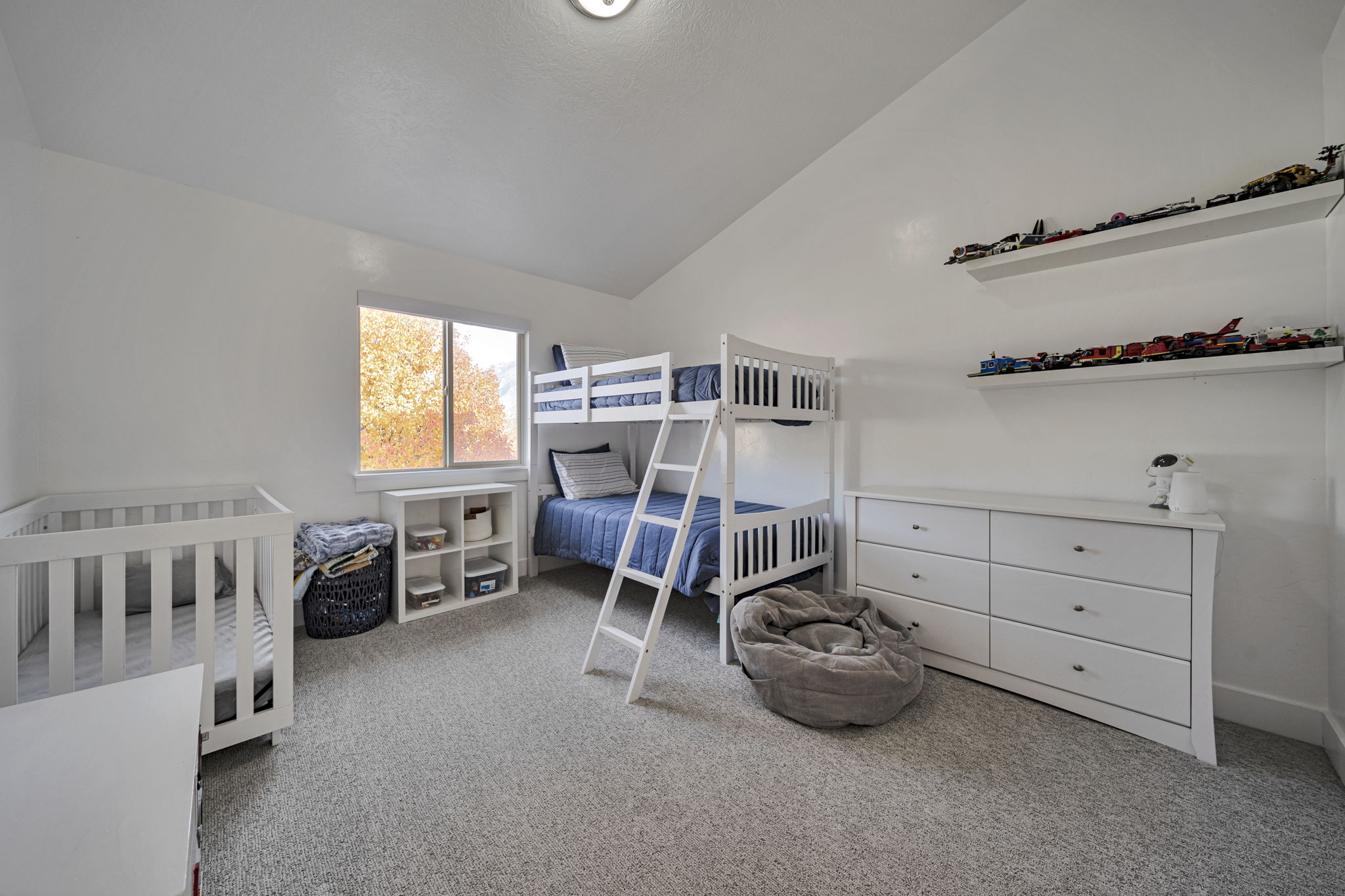 Bedroom featuring vaulted ceiling and light carpet
