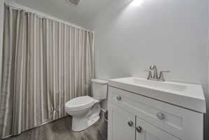 Bathroom featuring vanity, dark wood finished floors, and a textured ceiling