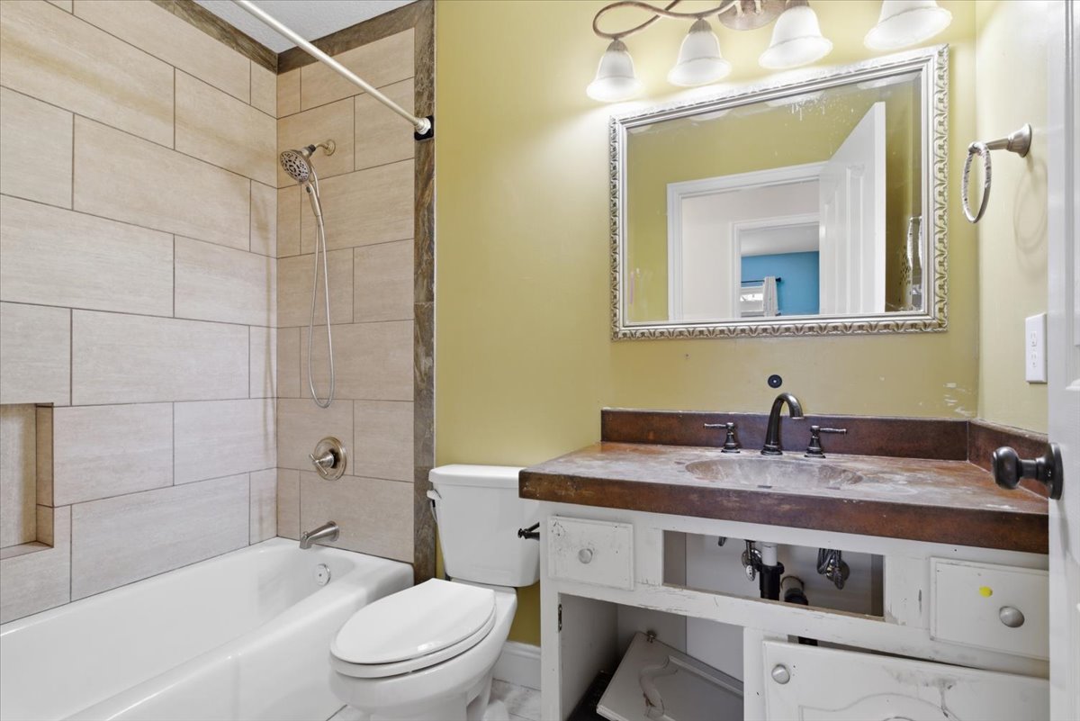 Full bath featuring shower / washtub combination and vanity