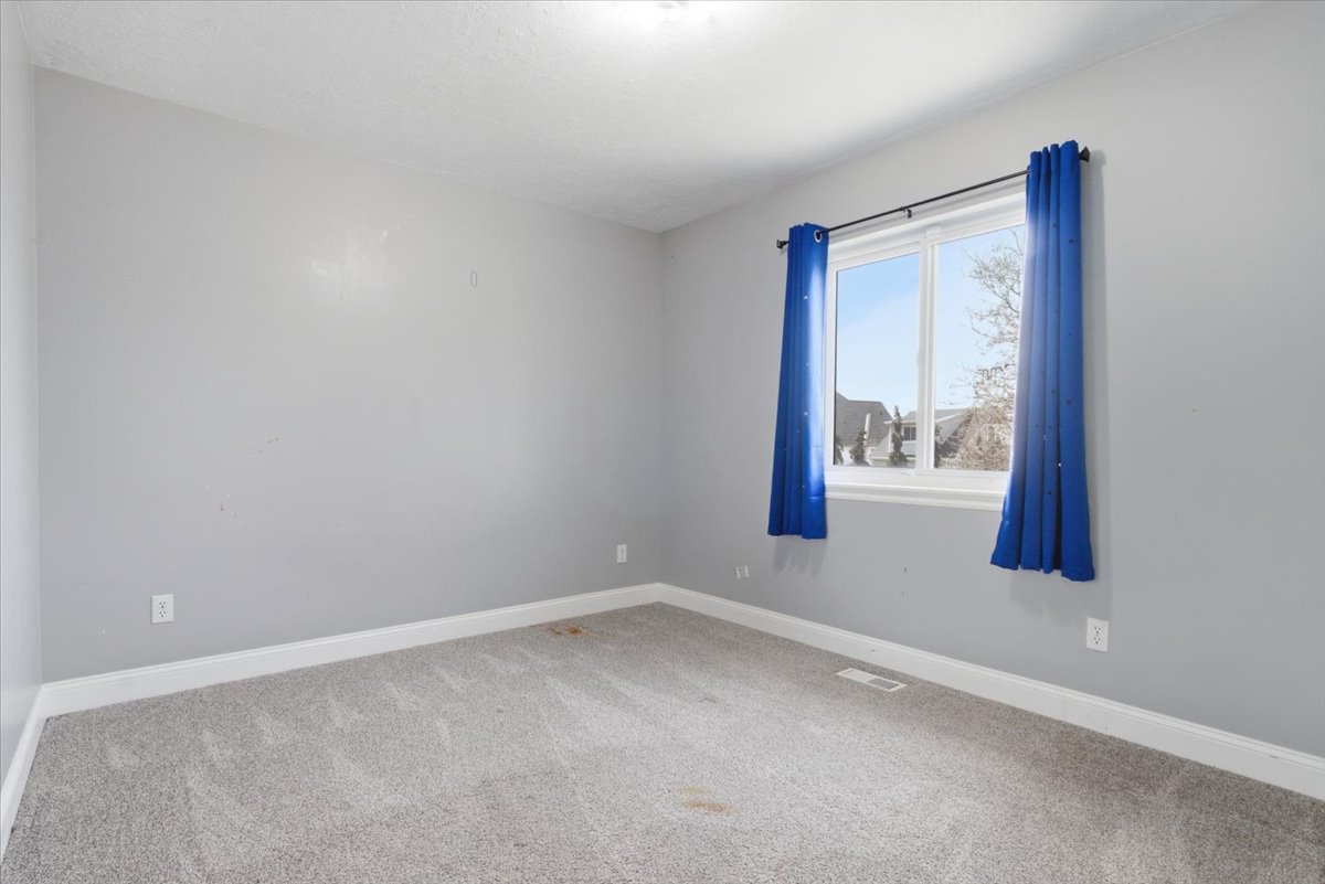 Unfurnished room featuring light colored carpet and baseboards