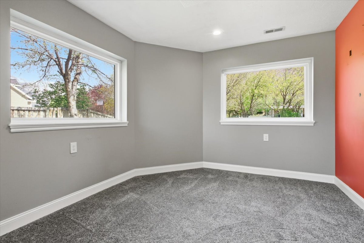 Carpeted empty room featuring baseboards