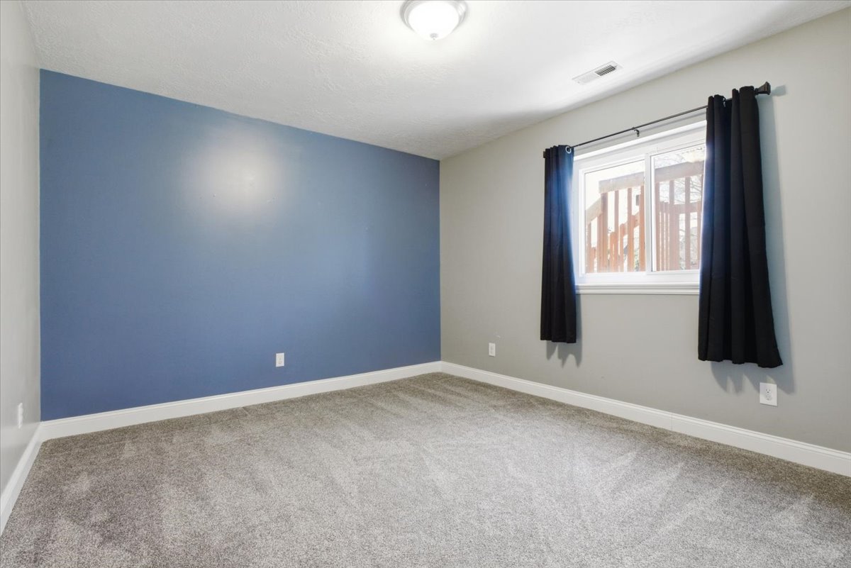 Spare room featuring baseboards and light carpet