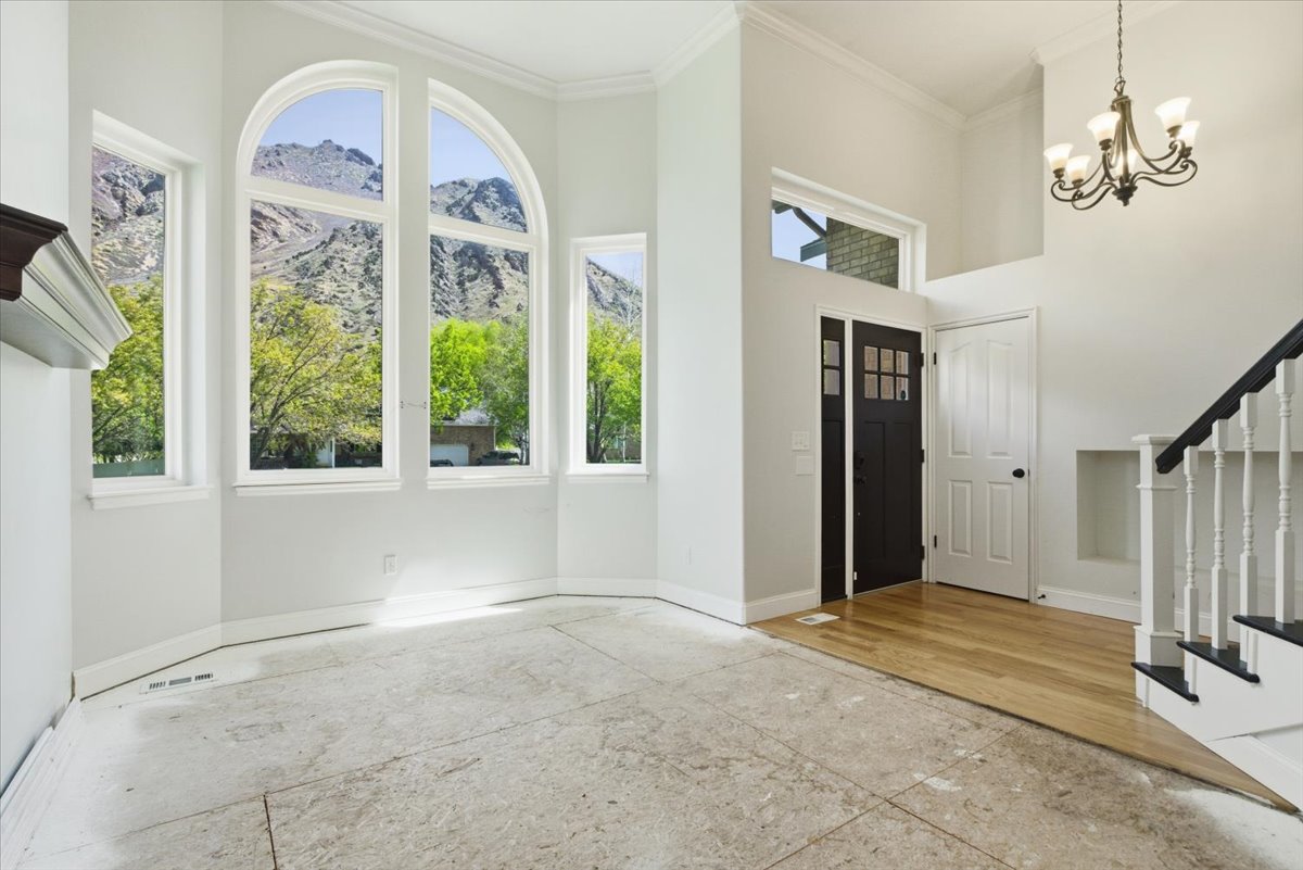 Entryway featuring a high ceiling, ornamental molding, suspended lighting, and a mountain view
