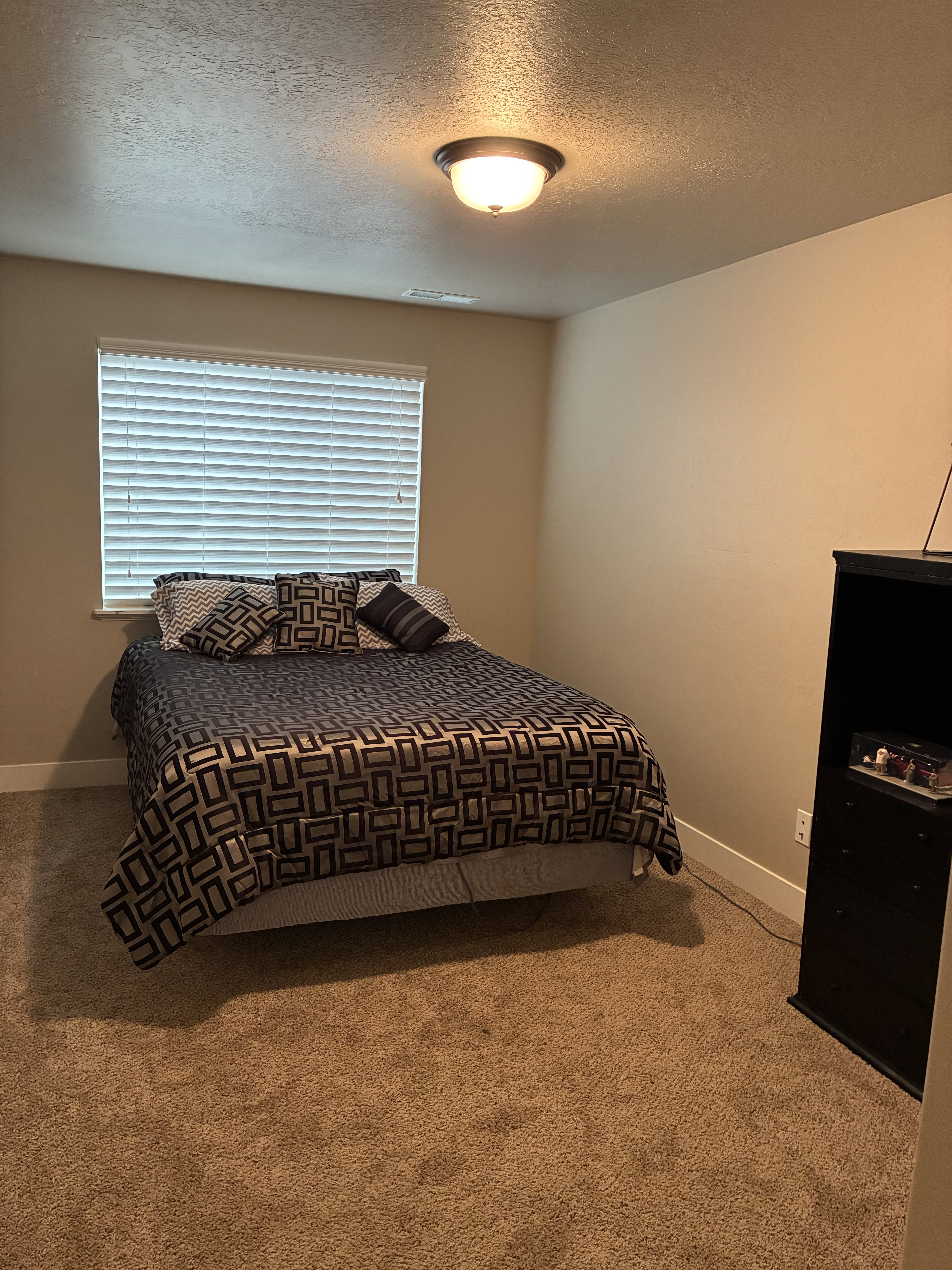 Bedroom featuring a textured ceiling and carpet floors