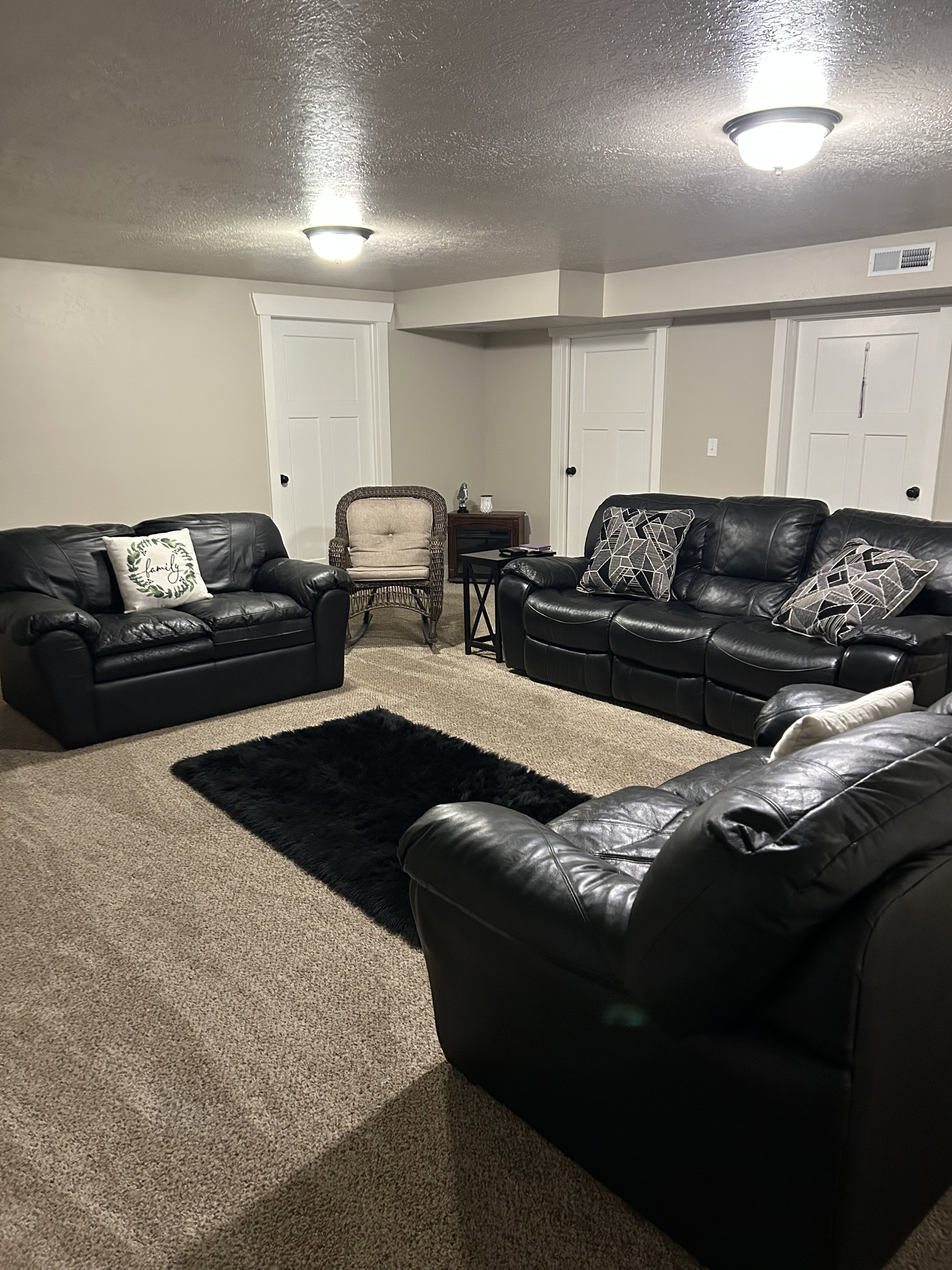 Living area with a textured ceiling and carpet floors