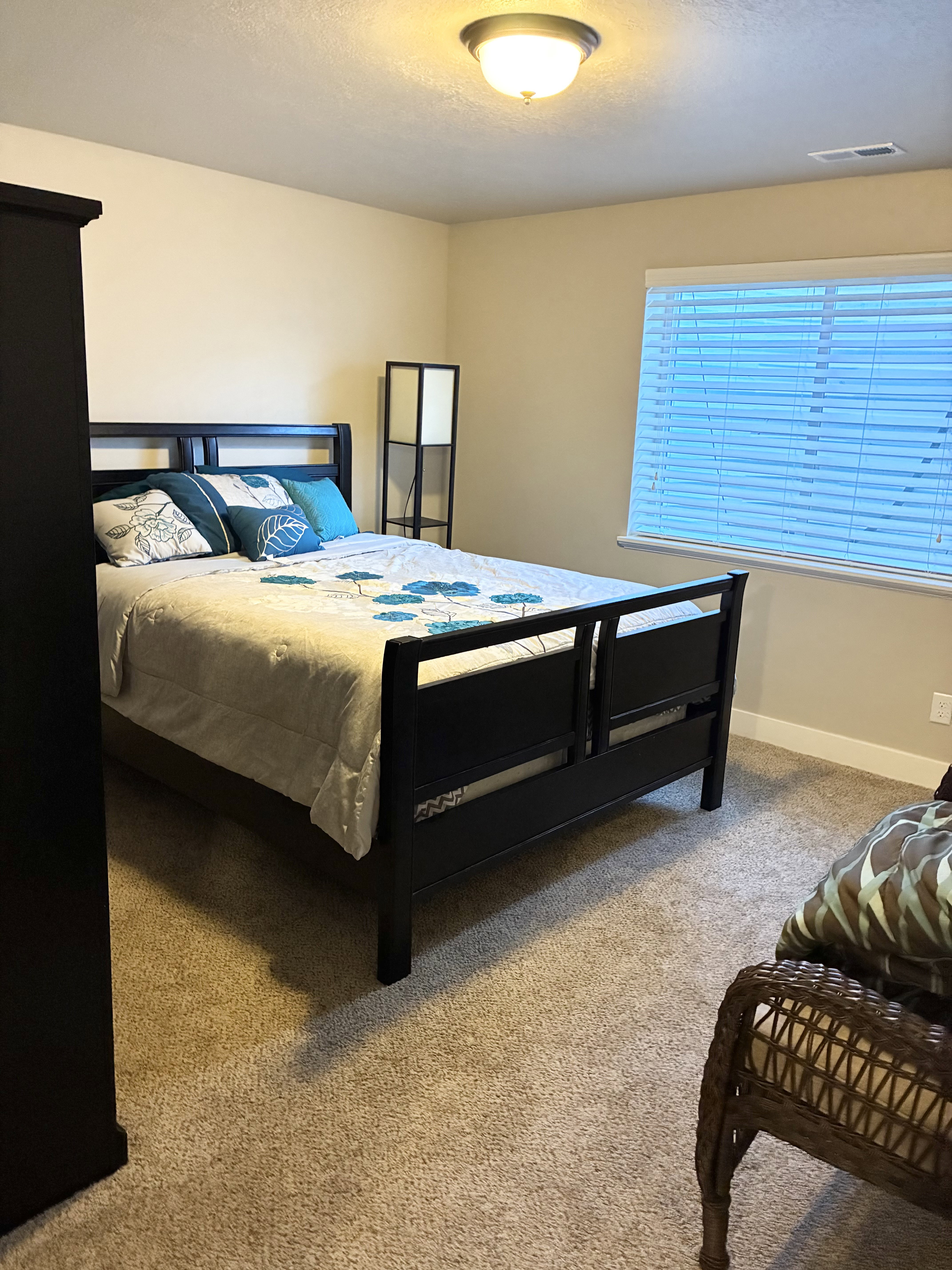Bedroom featuring baseboards and light carpet