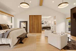 MAIN FLOOR PRIMARY BEDROOM SUITE WITH ANGLED PRIVACY WALNUT WALL