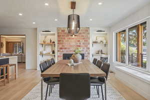 DINING AREA WITH EXPOSED ORIGINAL BRICK AND KITCHEN WITH BUTLER PANTRY