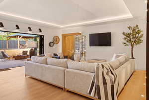 FAMILY ROOM WITH WINE ROOM AND EXPANSIVE FOLDING PATIO DOOR