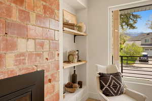 DINING AREA WITH EXPOSED ORIGINAL BRICK AND KITCHEN WITH BUTLER PANTRY