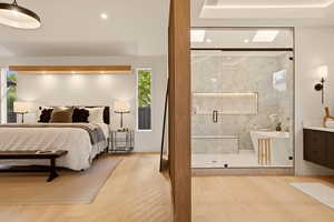 MAIN FLOOR PRIMARY BEDROOM SUITE WITH ANGLED PRIVACY WALNUT WALL