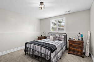 Bedroom with carpet flooring and a textured ceiling