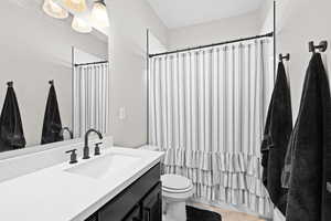 Full bathroom featuring vanity and shower / bathtub combination with curtain
