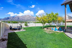 Fenced backyard with a patio area and a mountain view