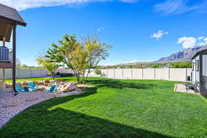 Fenced backyard featuring a patio and a mountain view