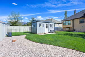 View of outdoor structure featuring a fenced backyard and a mountain view