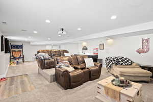 Living room featuring light carpet, recessed lighting, and light wood-type flooring