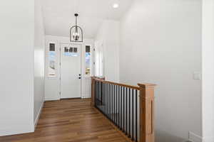 Entrance foyer featuring dark wood-type flooring and a chandelier