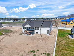 Rear view of house with a residential view, stucco siding, and a deck with mountain view