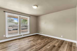 Unfurnished room featuring light wood-style flooring and baseboards