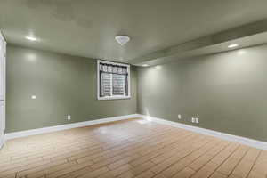 Empty room with wood finish floors and recessed lighting