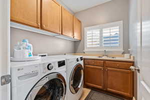 Laundry room featuring cabinet space, separate washer and dryer