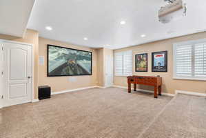 Home theater featuring light colored carpet and recessed lighting