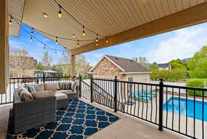 Balcony featuring view of pool and an outdoor hangout area