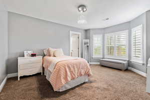Carpeted bedroom featuring baseboards